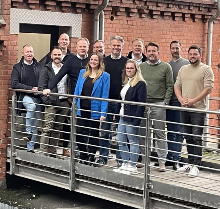Team standing in front of entrance