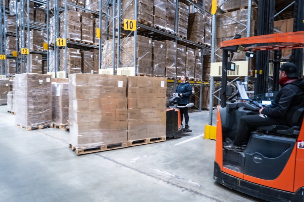 Woman moving packages inside warehouse