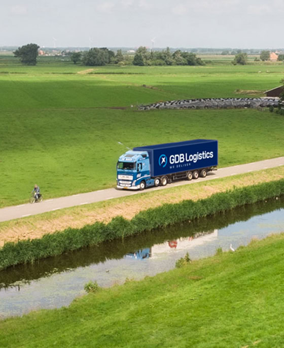 GDB Logistics truck driving through green environment